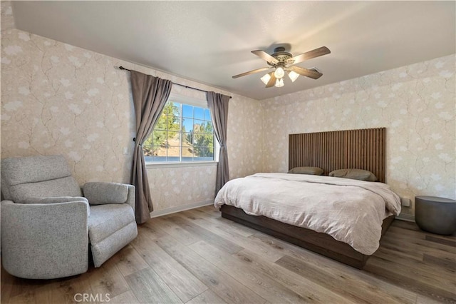 bedroom with ceiling fan and light hardwood / wood-style flooring