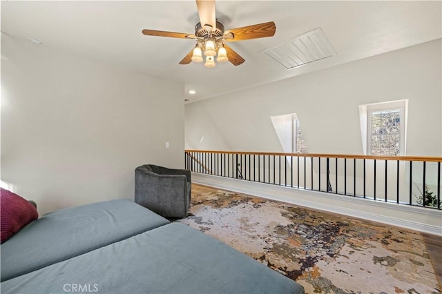 living area with ceiling fan and hardwood / wood-style floors