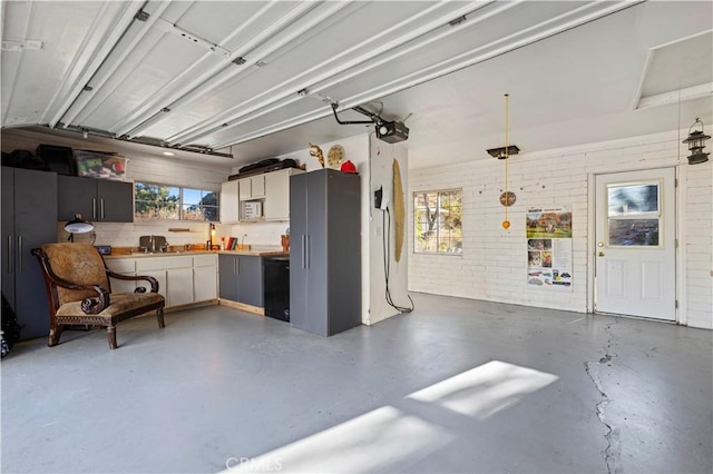 garage featuring sink and a garage door opener