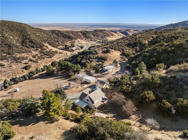 birds eye view of property featuring a mountain view