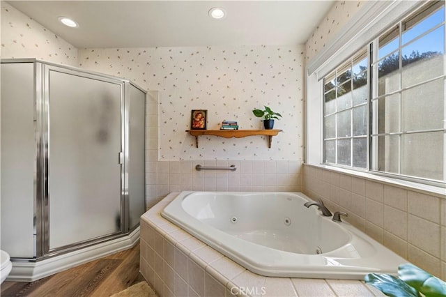 bathroom featuring wood-type flooring and separate shower and tub