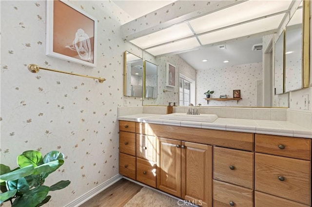 bathroom with vanity and hardwood / wood-style flooring