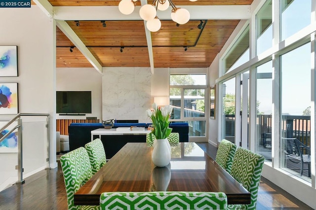 dining space featuring a notable chandelier, a towering ceiling, wooden ceiling, and beamed ceiling