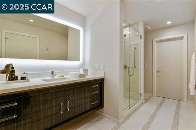 bathroom featuring vanity, a shower with door, and tile patterned flooring