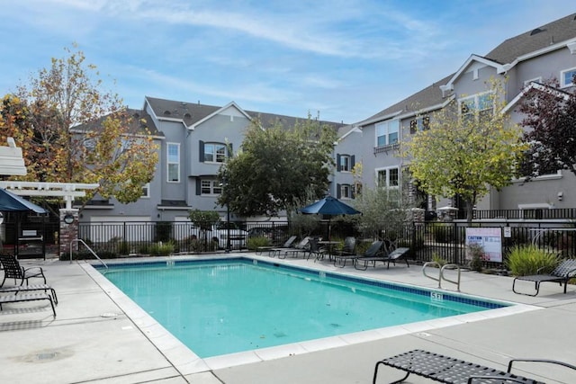 view of swimming pool featuring a pergola and a patio area