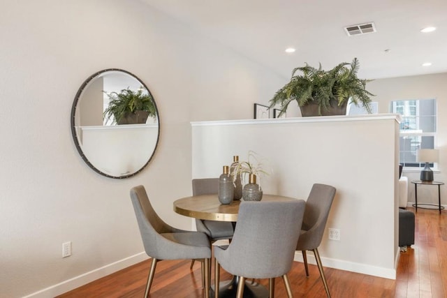 dining space featuring wood-type flooring