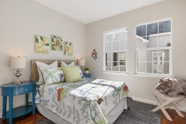 bedroom with dark wood-type flooring