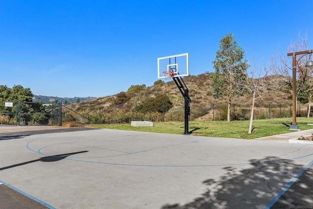 view of basketball court with a lawn