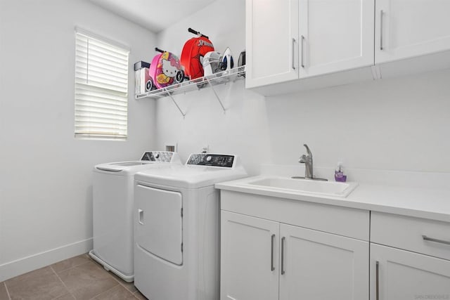 washroom featuring washer and clothes dryer, light tile patterned flooring, sink, and cabinets