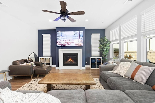 living room featuring ceiling fan and hardwood / wood-style floors