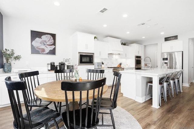 dining area with sink and hardwood / wood-style floors