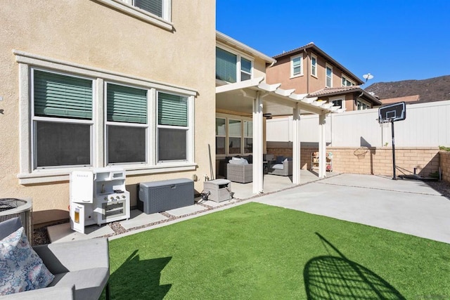 back of property with outdoor lounge area, a pergola, a lawn, and a patio