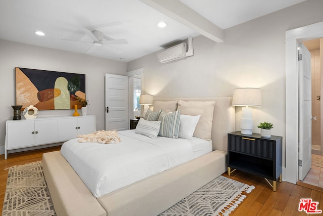 bedroom featuring hardwood / wood-style flooring, beamed ceiling, an AC wall unit, and ceiling fan