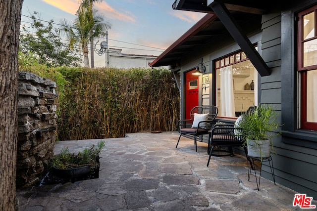 view of patio terrace at dusk