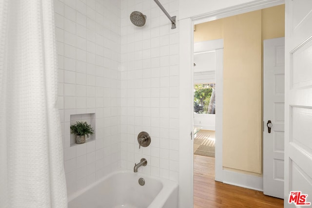 bathroom featuring hardwood / wood-style floors and shower / bath combo