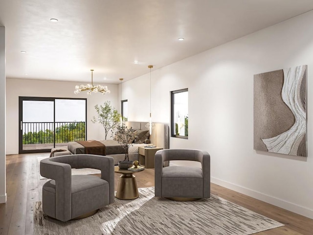 living room featuring an inviting chandelier and hardwood / wood-style floors