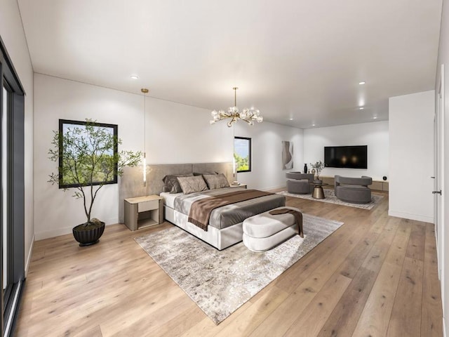 bedroom featuring an inviting chandelier and light hardwood / wood-style floors