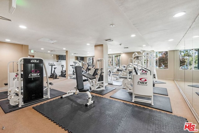 gym with a textured ceiling