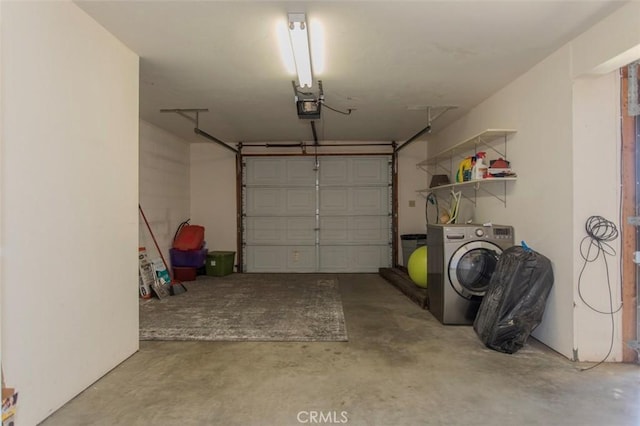 garage with a garage door opener and washer / clothes dryer