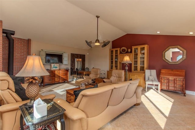 living room featuring ceiling fan, light tile patterned floors, lofted ceiling, and a wood stove