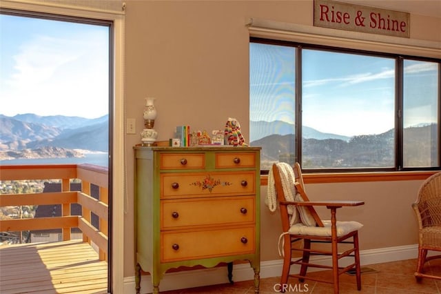 sitting room featuring tile patterned floors and a mountain view