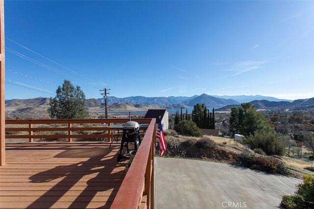 wooden terrace featuring grilling area and a mountain view