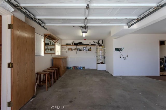 garage with a garage door opener and strapped water heater