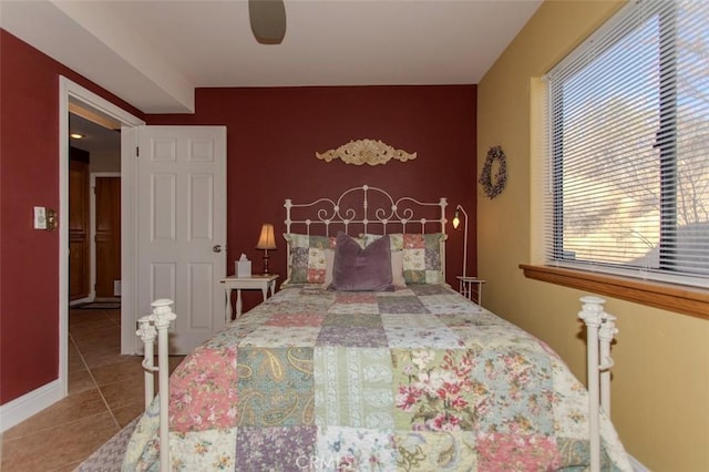 tiled bedroom featuring ceiling fan