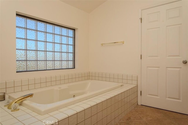 bathroom featuring a relaxing tiled tub and tile patterned floors