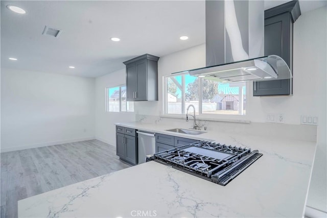 kitchen featuring light hardwood / wood-style floors, island exhaust hood, stainless steel appliances, gray cabinetry, and sink