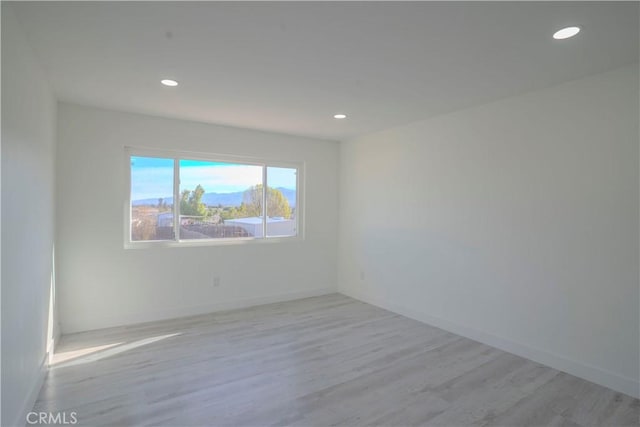 empty room with light hardwood / wood-style floors