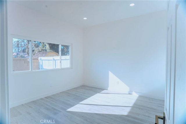 spare room with light hardwood / wood-style flooring