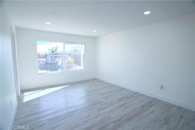 empty room with hardwood / wood-style floors