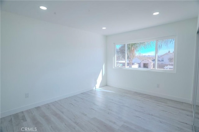 unfurnished room with light hardwood / wood-style floors