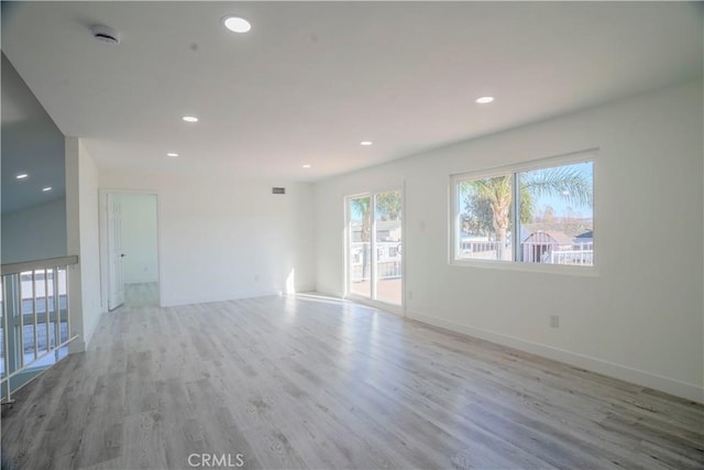 empty room with light hardwood / wood-style flooring