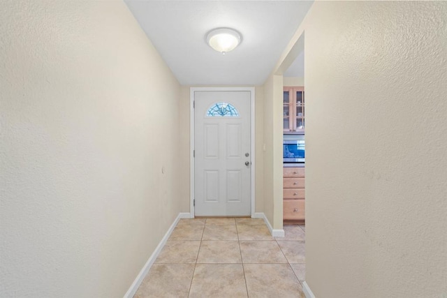 entryway with light tile patterned floors