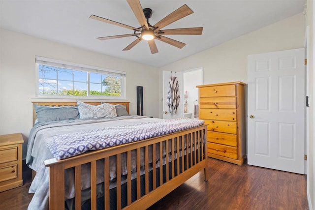 bedroom featuring ceiling fan, dark hardwood / wood-style flooring, and vaulted ceiling