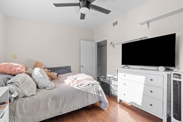 bedroom featuring ceiling fan and dark hardwood / wood-style floors