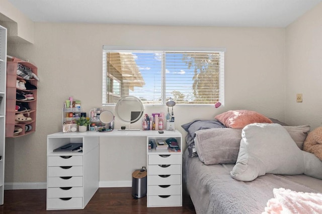 bedroom with dark hardwood / wood-style flooring