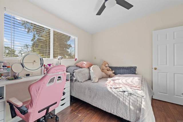 bedroom featuring multiple windows, dark hardwood / wood-style flooring, and ceiling fan