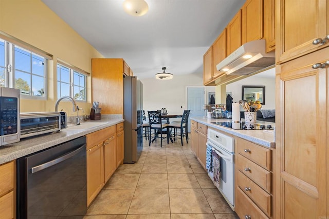 kitchen with appliances with stainless steel finishes, sink, and light tile patterned floors