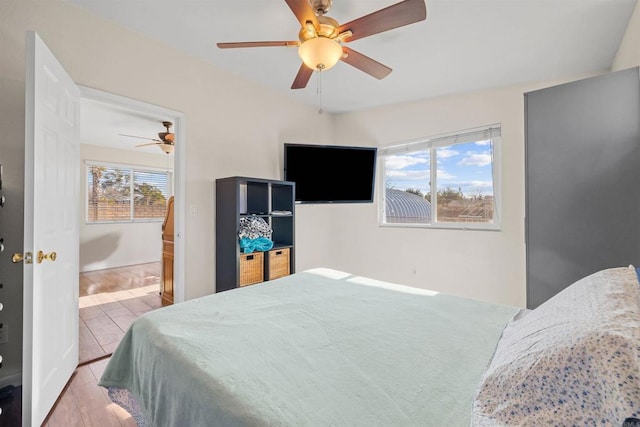 bedroom with ceiling fan and light wood-type flooring