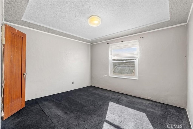 unfurnished room featuring crown molding, a textured ceiling, and dark colored carpet