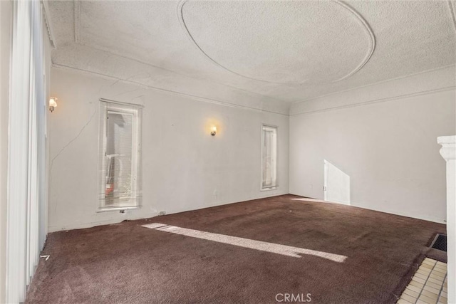 carpeted spare room featuring a textured ceiling