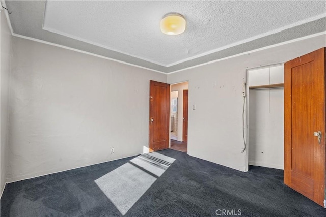 unfurnished bedroom featuring dark carpet, a closet, and a textured ceiling