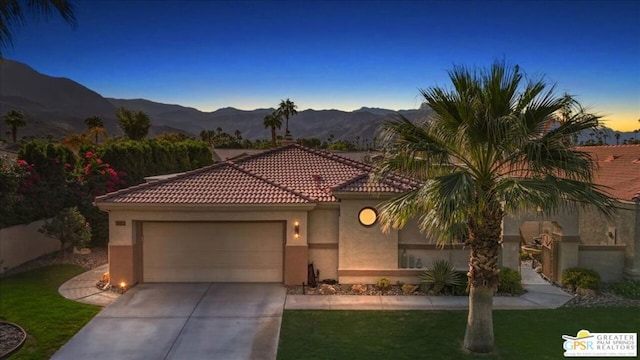 view of front facade featuring a garage and a mountain view