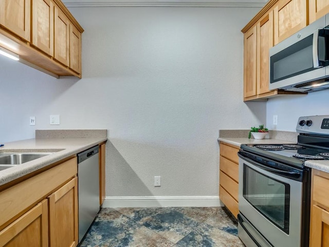 kitchen featuring stainless steel appliances and light brown cabinetry