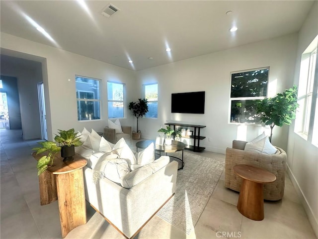 tiled living room featuring a healthy amount of sunlight