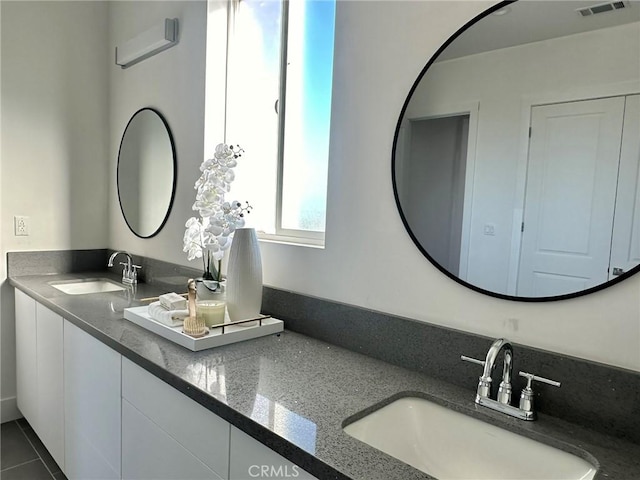 bathroom with tile patterned floors and vanity