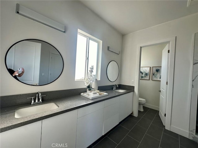 bathroom with vanity, toilet, and tile patterned flooring